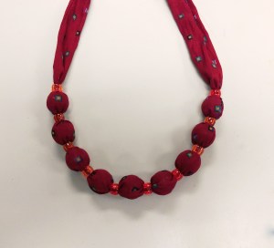 Vintage style fabric necklace made using marbles inside a fabric tube with pony beads in between
