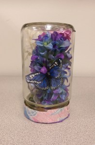 Decorative Terrarium by Michelle : All you need is an empty salsa jar, some fabric flowers on stems, ribbon to wrap around the lid base, and a little bit of creativity.